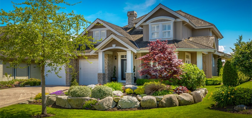 new home with landscaping in middle of a sunny afternoon