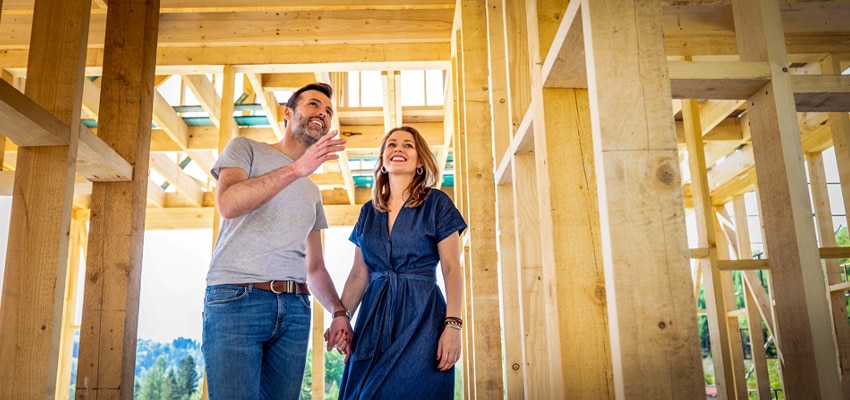 new home construction with happy young couple