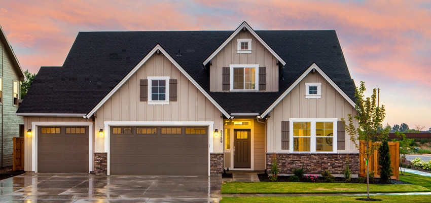 Three-car-garage-early-evening-after-light-rain-and-lights-are-on